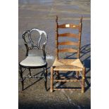 A rush seat ladder back chair, on bobbin turned supports, and an ebonised and mother-of-pearl inlaid