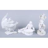 A Continental porcelain salt in the form of a reclined gentleman, a figure of a girl holding a