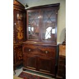 A late Georgian figured mahogany secretaire bookcase, the upper section enclosed astragal glazed