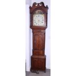 A late Georgian oak end mahogany banded long case clock with landscape painted arch top dial and