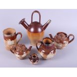 A Doulton Lambeth brown glazed pottery jug with silver rim, a similar tankard, two teapots and two
