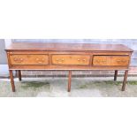 A late 18th century oak and walnut banded dresser base, fitted three drawers with bail handles, on