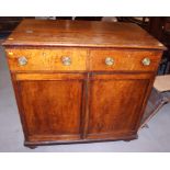 A 19th century mahogany side cupboard with lift up top and faux drawers over two doors, on bracket