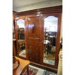 An Edwardian mahogany and banded wardrobe, fitted central cupboard over four drawers and flanking
