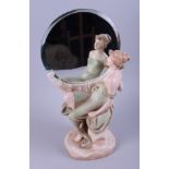 An Art Nouveau circular toilet mirror, with seated figure, 17" high