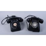Two black Bakelite rotary dial telephones