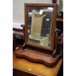 A mahogany swing frame toilet mirror, on plateau base, 17" wide