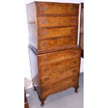 A burr walnut chest on chest of eight long graduated drawers, on cabriole supports, 26" wide