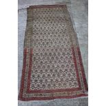 A Persian tribal rug with all-over "carnation" design on a light ground, 44" x 92" approx