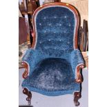 A Victorian spoon back showframe nursing chair, button upholstered in a blue velvet, on cabriole