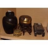 A set of three black and gilt lacquered nesting boxes, a Chinese lacquered ginger jar, two carved