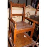 A child's 19th century elm and oak panel seat rocking chair