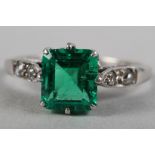 An Art Deco platinum ring set Columbian emerald, 0.75ct approx, with diamond accents to the