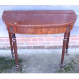 A George III mahogany bowfront fold-over card table, on reeded castored supports, 36" wide