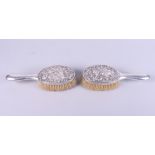 A pair of Chinese silver brushes with embossed dragon and cloud decoration, makers mark for Wang