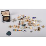 A selection of military and other buttons, badges, etc
