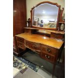 An Edwardian mahogany and satinwood break bowfront dressing chest with mirror and jewel drawers over