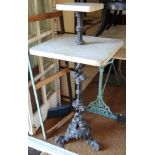 A 19th century two-tier marble top conservatory table, on cast iron dolphin decorated tripod