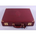 A Cartier burgundy leather briefcase with metal borders