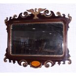 A mahogany and gilt framed wall mirror of early Georgian design with eagle crest, bevelled plate