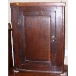 An 18th century oak corner hanging cupboard enclosed panel door, 26" wide
