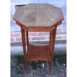 An Edwardian mahogany and satinwood inlaid octagonal work table with sectional tier below, on