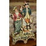 A late 19th century Continental pottery figure group, hunter with his lady, in period costume, 21"