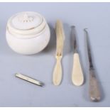 An ivory tobacco jar, two button hooks, a brush end and a pocket knife