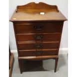 An Edwardian walnut music cabinet, fitted four drawers, on square taper supports, 20" wide