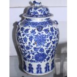 An 18th century Chinese blue and white jar and cover with all-over tendril design and lion mask