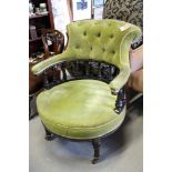 A late Victorian ebonised and gilt tub shape armchair with spindle back, button upholstered in a