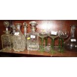 Four cut glass decanters, one with silver mount, and one other decanter