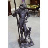 An anodised standard lamp, in the form of a Renaissance hunter with dog, 59" high