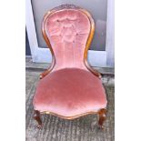 A Victorian carved walnut showframe spoon back occasional chair, button upholstered in a pink