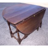 An 18th century oak oval drop leaf table, fitted one drawer, on baluster turned and stretchered