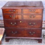 A Georgian mahogany chest of four short and two long graduated drawers with swan neck handles, on