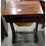 An early 19th century rosewood fold-over top work table with games interior over one drawer and