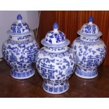 A set of three Chinese blue and white bulbous jars and covers, 13" high