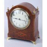 An Edwardian mahogany cased brass mounted arch top mantel clock with silvered dial and Arabic