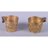 A pair of gilt metal replica Mycenaean mugs with embossed decoration