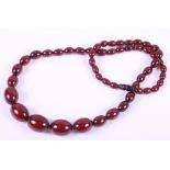 A cherry amber coloured graduated bead necklace, 31" long, 86g