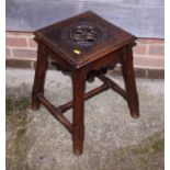 An oak Gothic Revival stool with carved decorative top, on chamfered "H" supports