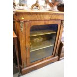 A late Victorian walnut and gilt brass mounted pier cabinet enclosed arch top door, on bracket feet,