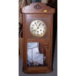 A mid 20th century oak cased wall clock