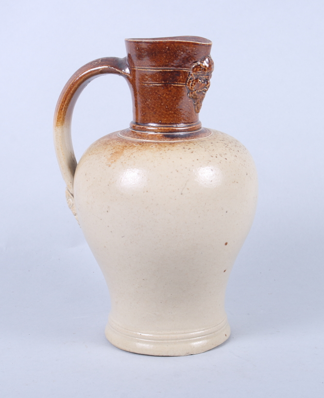 A Lambeth Stoneware jug with Silenus mask spout, 7" high (small rim chip)