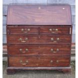 A 19th century padauk mahogany bureau of two short and three long drawers with brass fittings, on