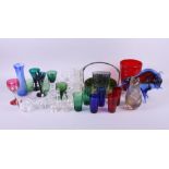 An assortment of glassware, including green tinted pedestal glasses, bark vases, a model of a