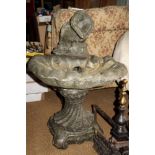 A cast stone shell-shape bird bath, on scroll base