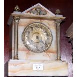 An onyx cased mantel clock with brass flanking columns and eight-day striking movement, 11" high