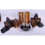 A silver plated stand, two pewter cups, a painted metal plate, a pair of wooden bookends with